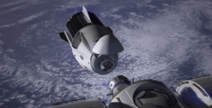 Crew Dragon během připojování k ISS - povšimněte si odklopného krytu v přední části, trunku se solárními panely i stabilizačních ploutví