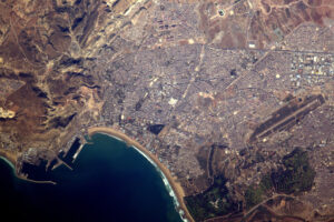 Město Agadir v Maroku. Fotbalový stadion je v horní části fotografie, golfové hřiště ve spodní.