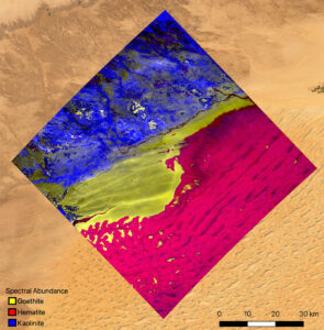 Minerální mapa oblasti v jihozápadní Libyi v pouští Sahara vytvořená z pozorování přístrojem EMIT. Dominuje zde kaolinit, světle zbarvený jílovitý minerál, který odráží sluneční záření. Jsou tu také dva oxidy železa - hematit a goethit, které jsou tmavé, takže pohlcují teplo a ohřívají okolní vzduch.