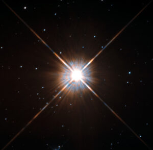Proxima Centauri, nejbližší hvězda (kromě Slunce) na snímku Hubbleova dalekohledu. 