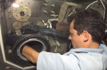 ESA astronaut Pedro Duque během mise Cervantes pracuje v rukavicovém boxu na experimentu PromISS 2 v americkém modulu Destiny. Obrázek zachycuje spolupráci evropských a amerických astronautů na orbitální laboratoři.